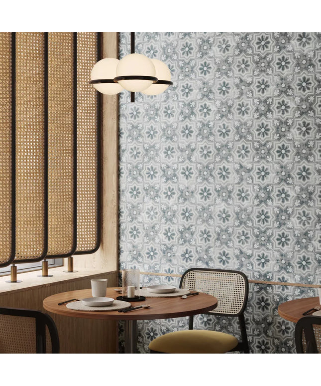 Dining area with patterned wallpaper, round table, and chairs.