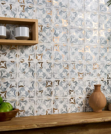 Decorative tile pattern on a wall with a wooden shelf and decorative items.