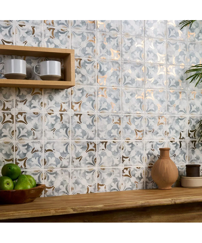 Decorative tile pattern on a wall with a wooden shelf and decorative items.