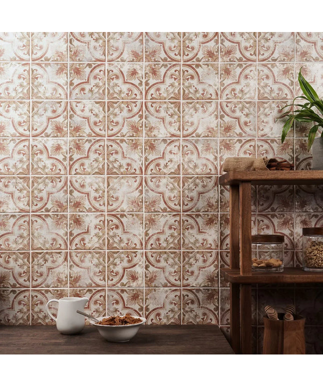 Decorative tile pattern on a wall with a wooden shelf and plants.