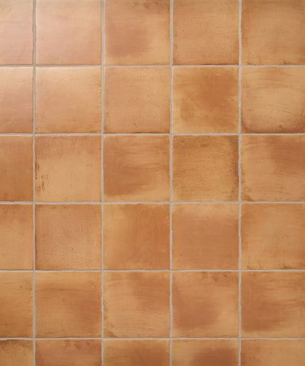 Peach terracotta 9x9 wall tiles with a rustic, matte finish for kitchen or bathroom walls.