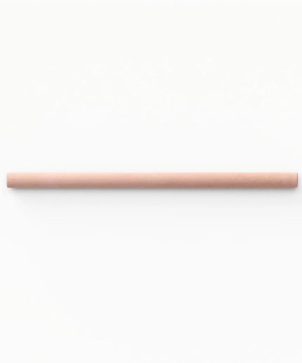 A single light peach-pink cylindrical stick or rod centered horizontally on a plain white background.