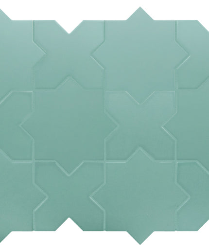 Teal ceramic tile with geometric pattern on a white background