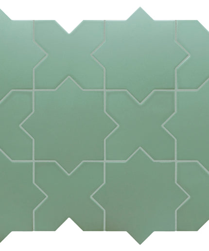 A sheet of sage green mosaic tiles with a repeating geometric star and chevron pattern, shown against a plain white background.