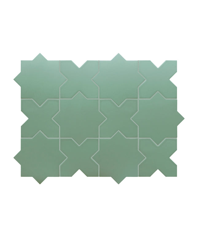 A sheet of sage green mosaic tiles with a repeating geometric star and chevron pattern, shown against a plain white background.