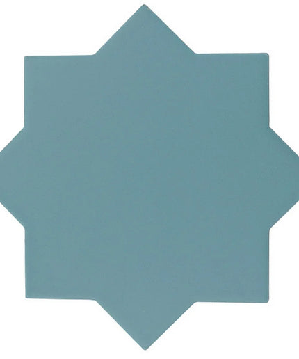 A solid slate blue geometric star-shaped tile or coaster on a plain white background.
