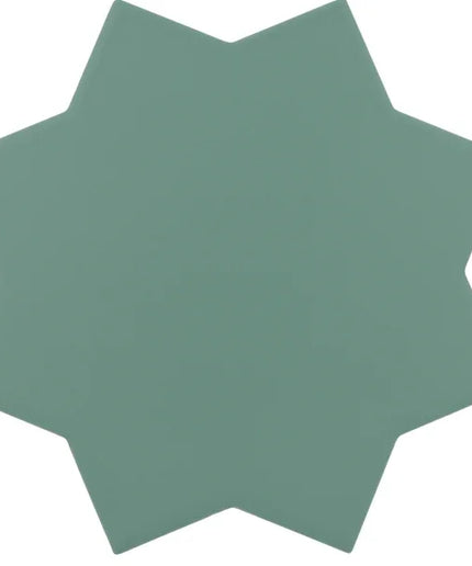 A single star-shaped tile or coaster in a muted sage green color, shown against a plain white background.