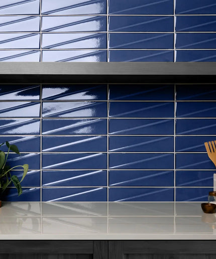 Kitchen with blue tiled wall and white countertop