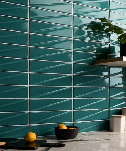 Teal tiled wall with a bowl of fruit and a plant in the corner