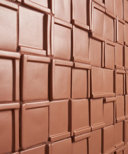 Close-up of a chocolate bar with square segments