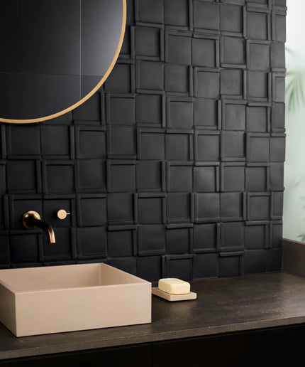 Bathroom vanity with beige sink, black textured wall, and round mirror.