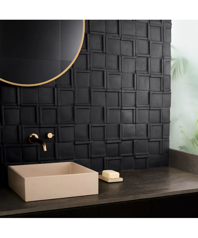 Bathroom vanity with beige sink, black textured wall, and round mirror.