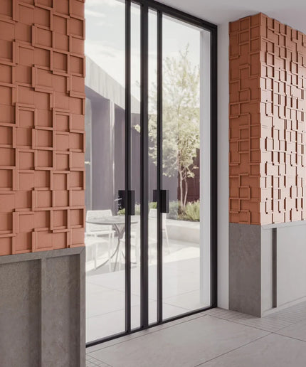 Modern architectural design with textured brick walls and glass doors.