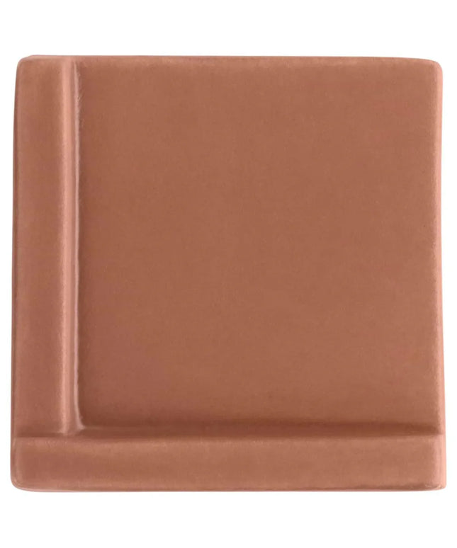 Square brown ceramic plate on a white background