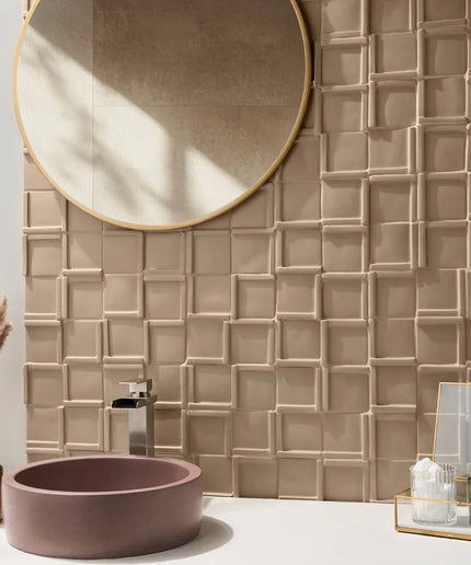 Bathroom with textured beige tiles, round mirror, and pink sink.