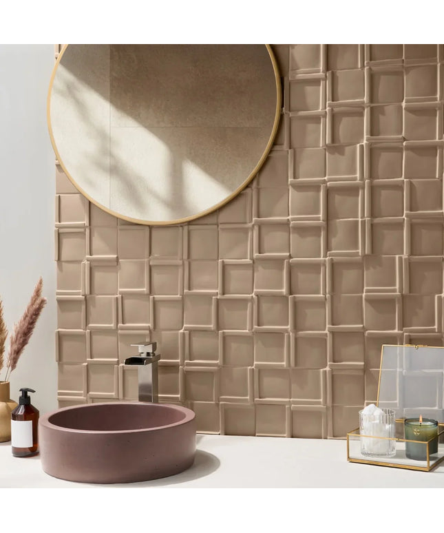 Bathroom with textured beige tiles, round mirror, and pink sink.