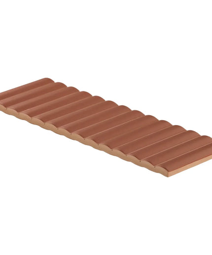 Row of terracotta-colored roof tiles on a white background