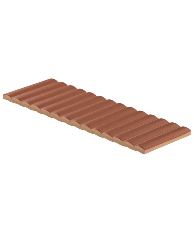 Row of terracotta-colored roof tiles on a white background