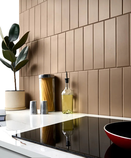 Taupe 3x11 subway tiles used as a modern kitchen backsplash with countertop decor