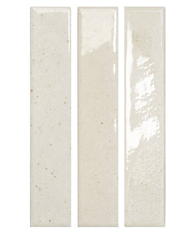 Three vertical rectangular ceramic subway tiles in a glossy off-white finish with subtle beige speckles and natural surface variation, shown side-by-side on a plain white background.