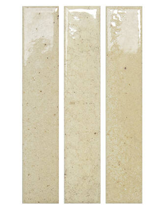Three tall, narrow rectangular ceramic subway tiles in a warm beige/cream glaze with subtle speckles, shown side-by-side on a white background.