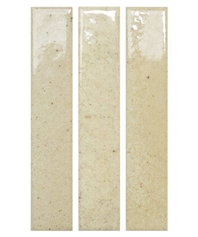 Three tall, narrow rectangular ceramic subway tiles in a warm beige/cream glaze with subtle speckles, shown side-by-side on a white background.
