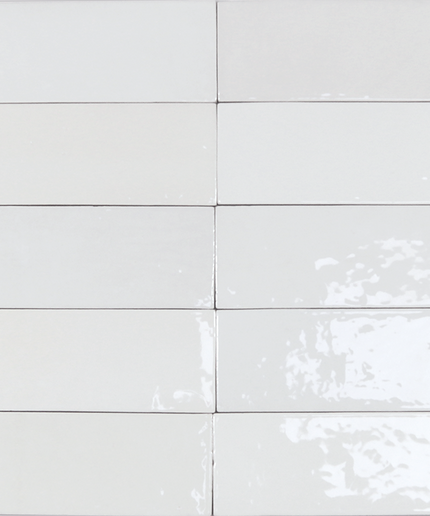 White ceramic tiles with subtle patterns on a white background