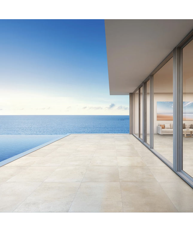 Modern house with a large glass door overlooking a blue ocean.