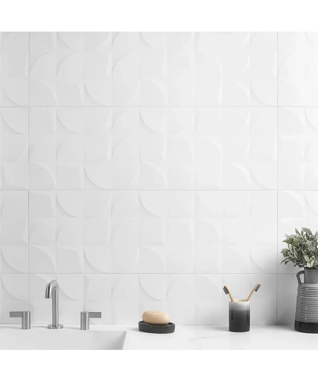 Bathroom with white tiled wall, sink, and decorative elements.