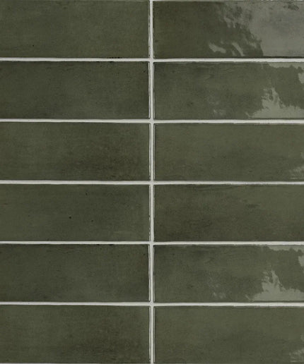 Glossy green 2x6 subway tiles with a reflective finish, ideal for backsplash or bathroom walls.