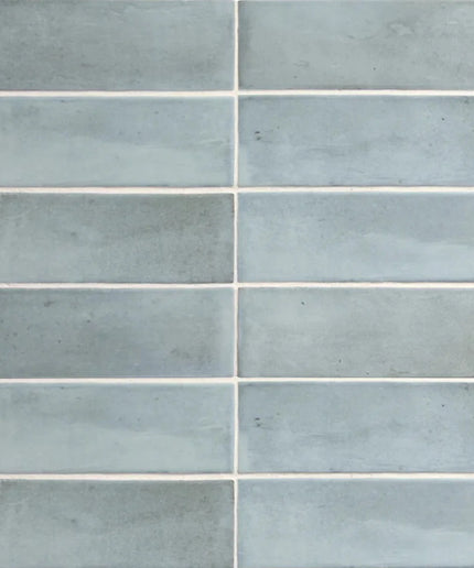 Glossy light blue rectangular tiles with subtle texture, ideal for backsplash or shower walls.