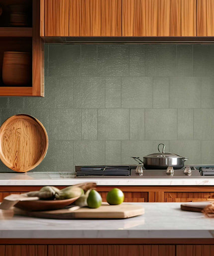 Sage mist 3x7 porcelain tile kitchen backsplash with stove and wood cabinetry