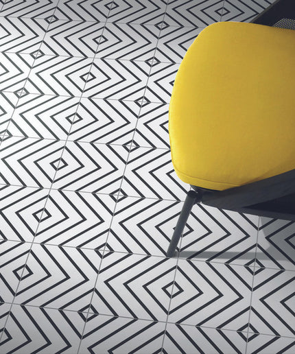 Geometric black and white floor tiles with a modern yellow chair