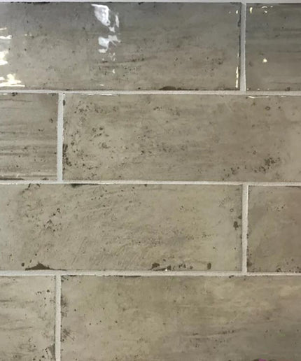 Glossy greige subway tile with rustic texture for kitchen backsplash or bathroom wall.
