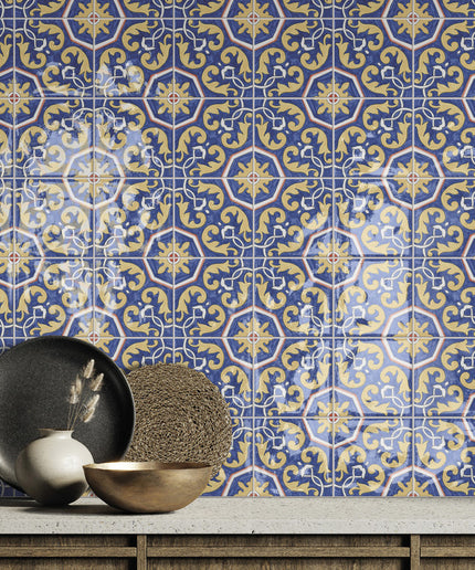 Blue and yellow patterned ceramic tile backsplash with decorative bowls on a countertop