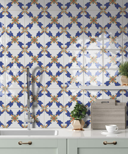 Colorful blue and orange patterned kitchen backsplash tiles above a modern sink and counter.