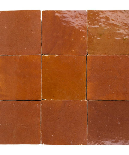 Nine square tiles with a terracotta color on a white background
