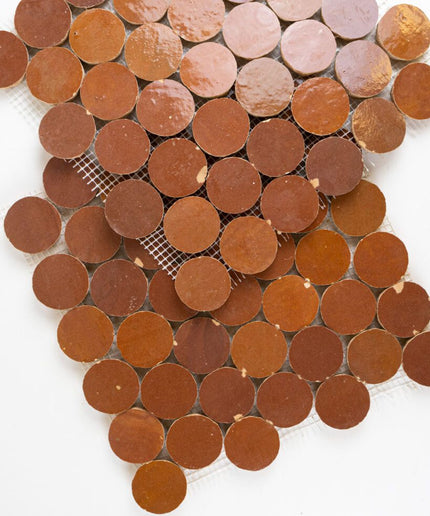 Sundried clay round mosaic tiles in warm earthy tones on mesh backing