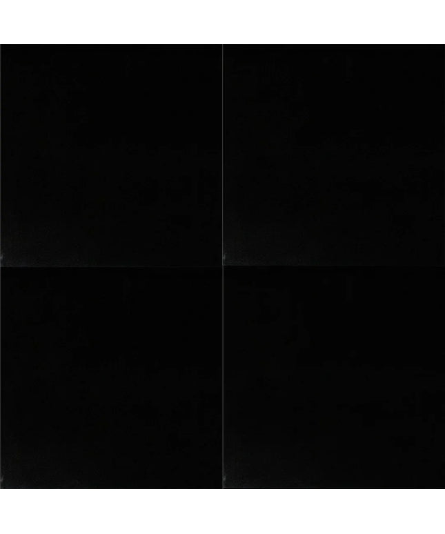 Black square tile with a subtle pattern on a black background