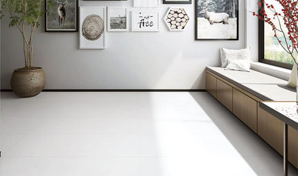 super white floor tiles modern living room with a window seat, decorative pillows, and framed pictures on the wall.