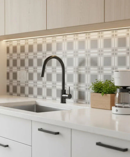 Modern kitchen backsplash with grey and white tartan pattern tiles behind sink and decor.