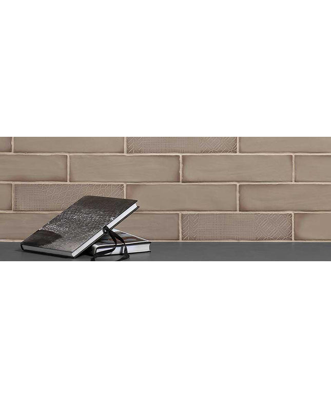 Two black notebooks stacked on a surface with a taupe subway tiled wall background