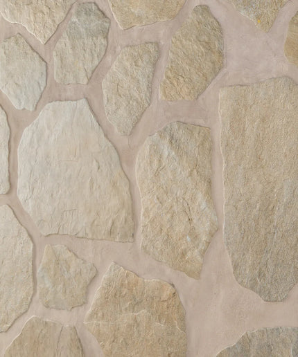 Close-up of a stone wall with beige and brown stones