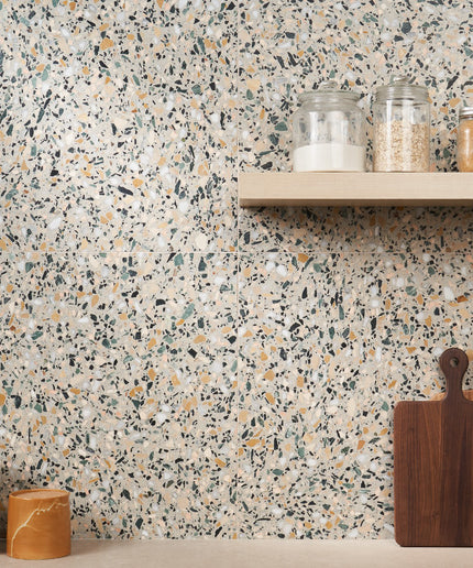 Terrazzo-style wall with a shelf and wooden cutting boards.