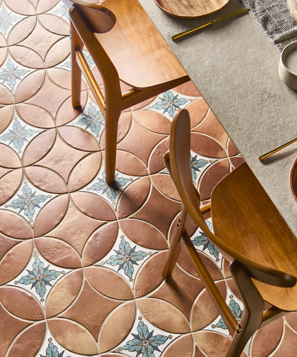 Patterned tiles with wooden chairs and a table setting.