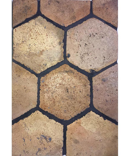 Terracotta hexagon floor tile with rustic yellow and brown tones, textured finish