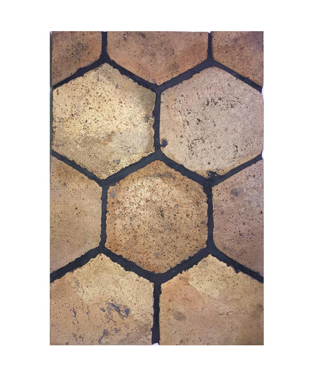 Terracotta hexagon floor tile with rustic yellow and brown tones, textured finish
