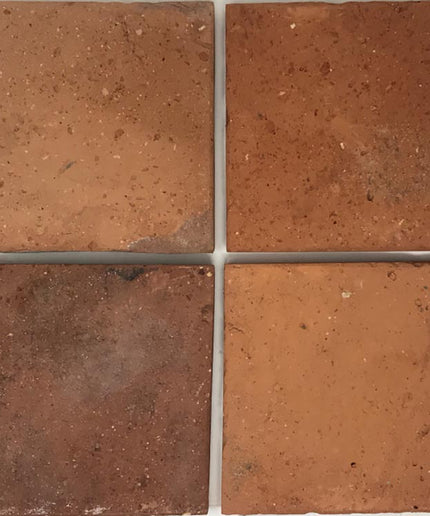 Four rustic terracotta 6x6 floor tiles with natural color variation and textured finish.