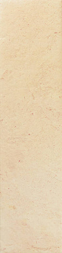 A close-up of a light beige stone or tile surface with subtle natural marbling and texture.