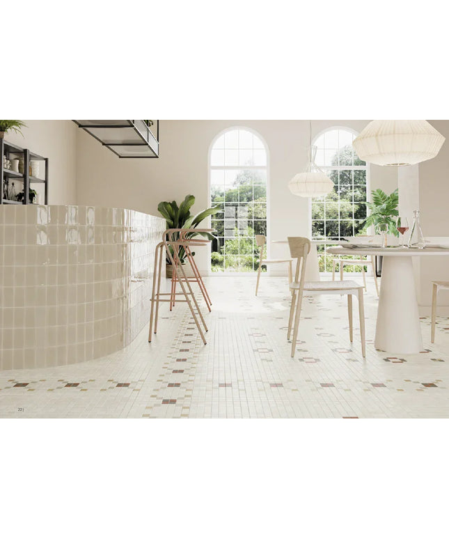 Modern kitchen with white tiled floor, white cabinets, and a dining area.
